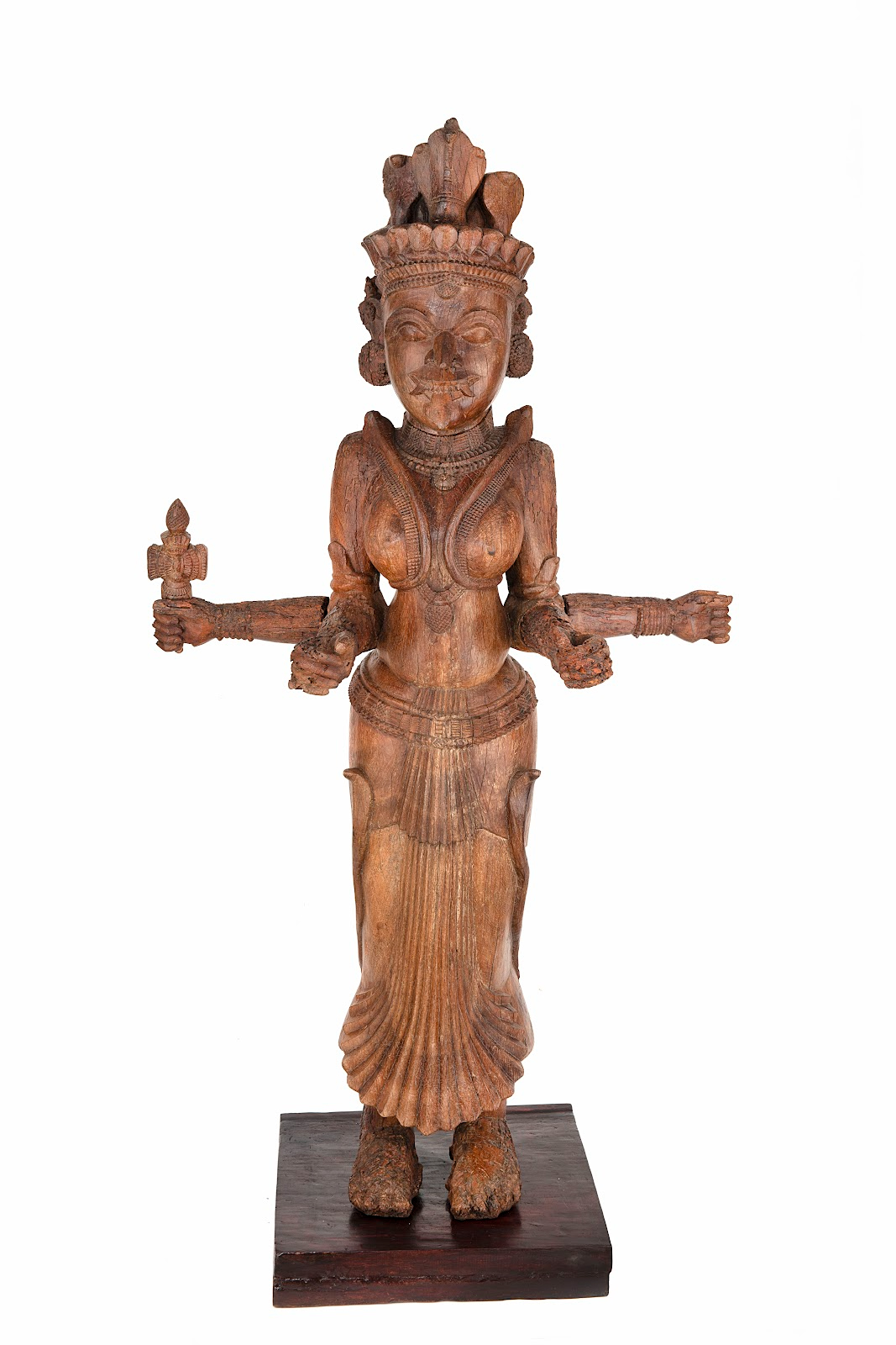 This wooden, life-size daiva sculpture of Bhagavati, the Mother Goddess. She has four arms, holds her tongue out and has traces of kumkum or vermillion powder on her. 