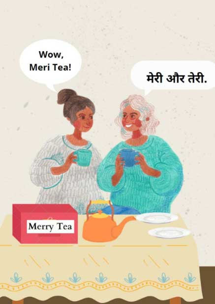 Illustration of two women in sweaters holding blue teacups and standing in front of a table with an orange teapot, white plates and a red box with the words “Merry Tea”. The woman on the left wearing a grey sweater, has a speech bubble above her which says “Wow Meri tea”. The woman on the right wearing a blue sweater has a speech bubble which says in Hindi “Meri aur Teri” (meaning, mine and yours). 