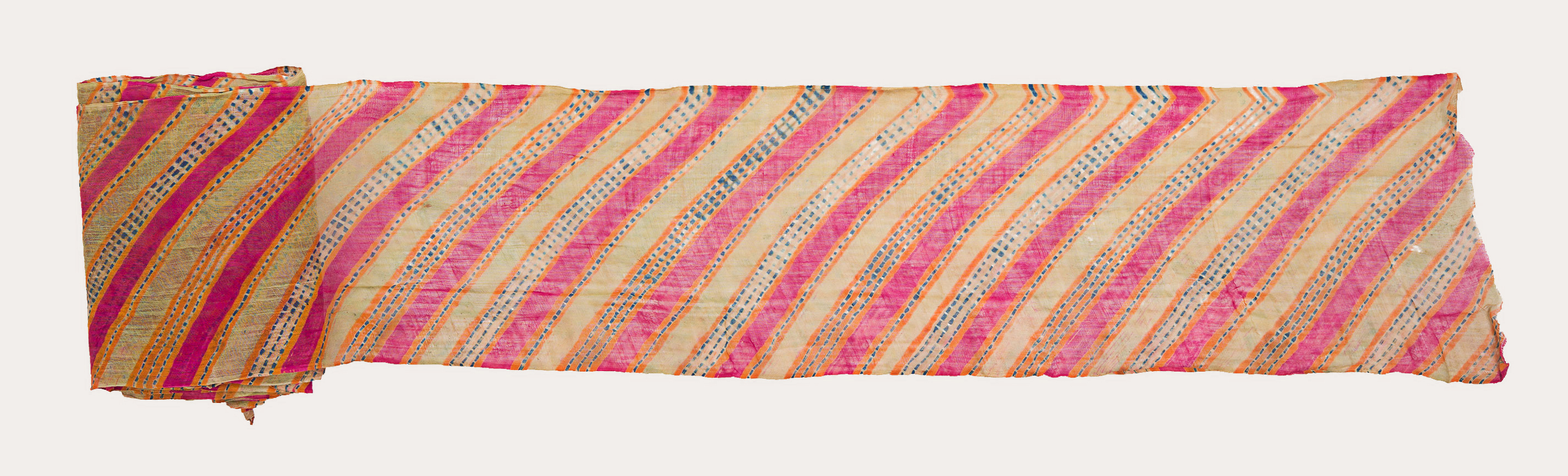 A long piece of rectangular cloth rolled from the right side. The left side shows us the narrow cloth with symmetrically spaced diagonal stripes.