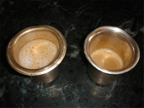 Two cups containing coffee