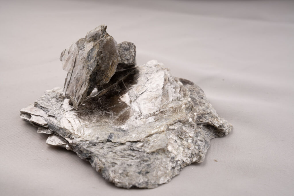 A sample of mica rock, showcasing the characteristic sheet structure of this metamorphic material. On view at The Forgotten Souvenir, the Museum of Art & Photography